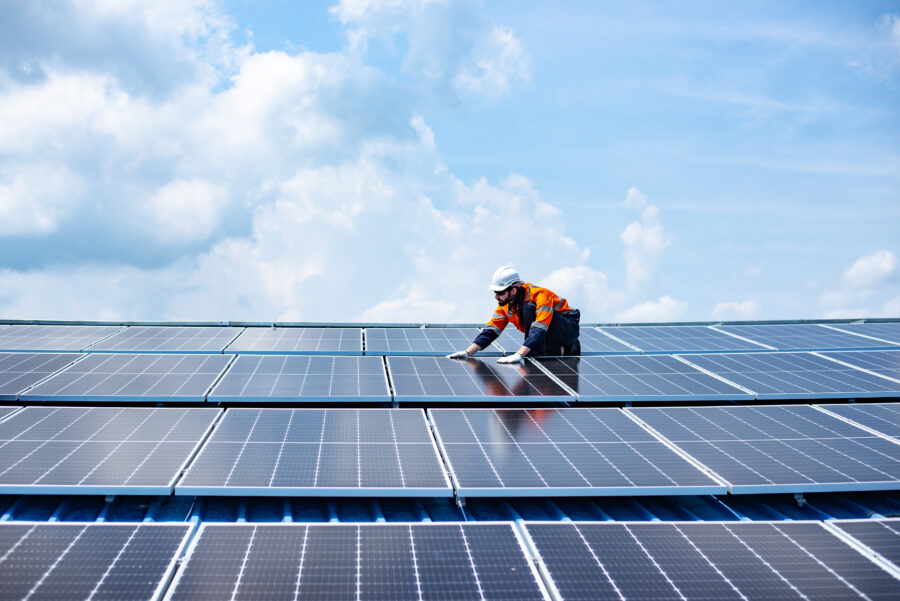 Engineer service check installation solar cell on the roof of factory.